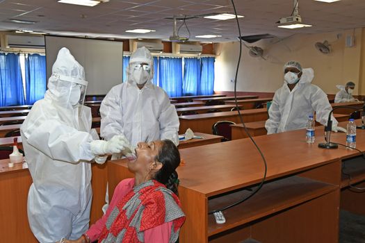 Burdwan Town, Purba Bardhaman District, West Bengal / India - 24.06.2020: Health workers are collecting samples of asymptomatic journalist for COVID-19 (Novel Coronavirus) test in the initiative of Purba Bardhaman District Health Department.