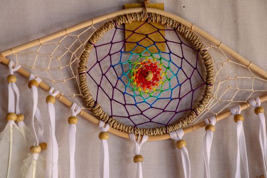 god eye of providence dreamcatcher with white feathers on a white background.