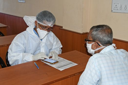 Burdwan Town, Purba Bardhaman District, West Bengal / India - 24.06.2020: Health workers are collecting samples of asymptomatic journalist for COVID-19 (Novel Coronavirus) test in the initiative of Purba Bardhaman District Health Department.