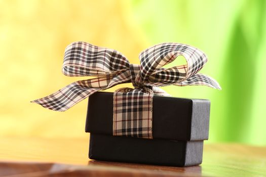 Presents on a table with a bow. Background space for copy. For Christmas, birthday or other holiday cards