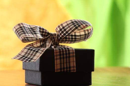 Presents on a table with a bow. Background space for copy. For Christmas, birthday or other holiday cards