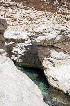 Clear blue green water of the river going thru Wadi Bani Khalid, sultanate of Oman. This is one of the most visited place of the country