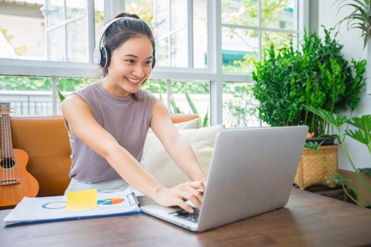 Asian businesswomen is using notebook computers and wear headphones for online meetings and working from home.