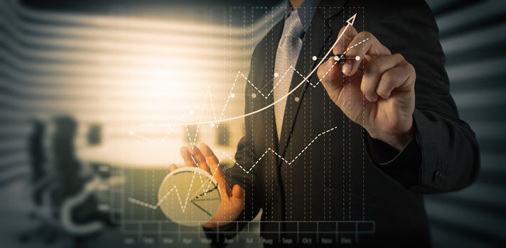 Close up of business man hand working on laptop computer with social media diagram and chart graph on wooden desk as concept