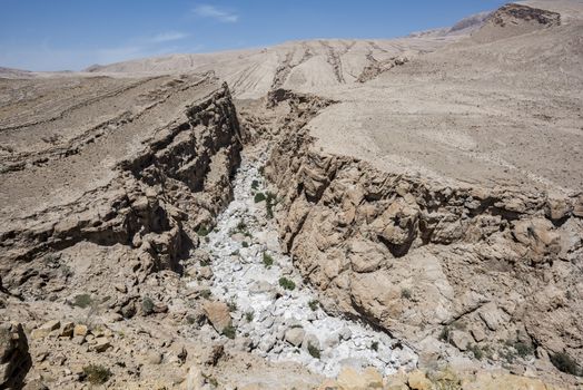 Dry river in the rocky and desert mountains of the Sultanate of Oman.