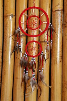 Red white blue Dreamcatcher on bamboo background.
