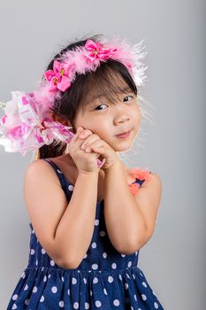Asian girl holding flowers in her hands.