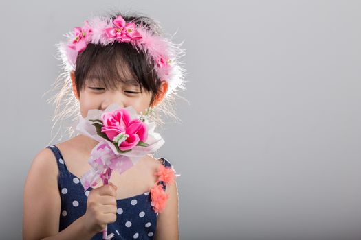 Background of Asian girl holding flowers in her hands.