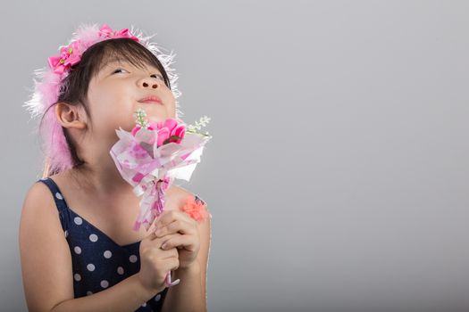 Background of Asian girl holding flowers in her hands.