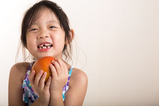 Child is holding an apple in her hands background.