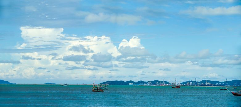 Panorama fishing boat and sailing on the sea industry background and blue sky