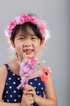 Background of Asian girl holding flowers in her hands.