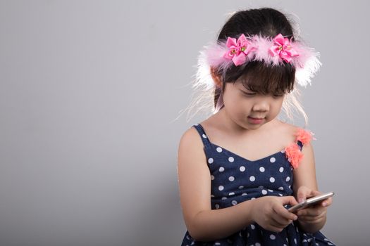 Background of Asian child is using smartphone.