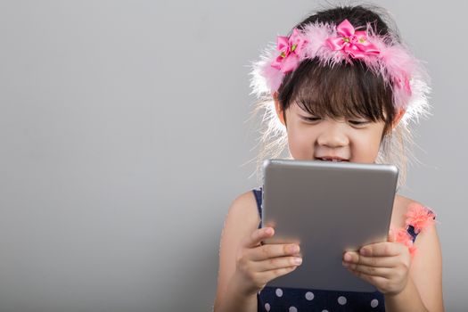 Background of Asian child is using tablet.