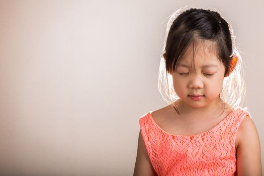 Little girl does mediation alone on with white background.