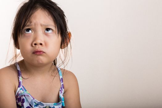 Little girl upsets with someone on isolated background.