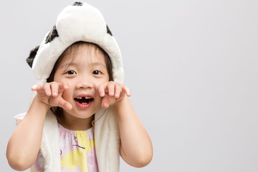 Pretty Asian girl pretending to be animal, panda, studio isolated white background.