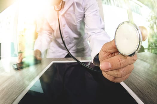 Medicine doctor hand working with modern digital tablet computer with  stethoscope as medical network concept