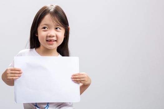 Studio isolated kid holding white sheet of blank paper.