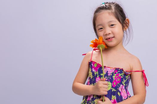 Child is holding sunflower in her hands background.