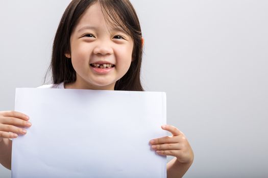 Studio isolated kid holding white sheet of blank paper.