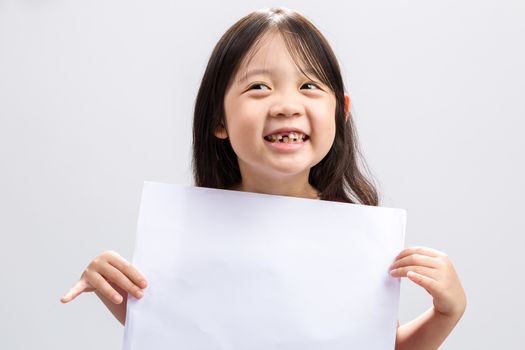 Studio isolated kid holding white sheet of blank paper.