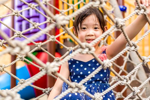 Young girl playing outdoor equipment with happiness.