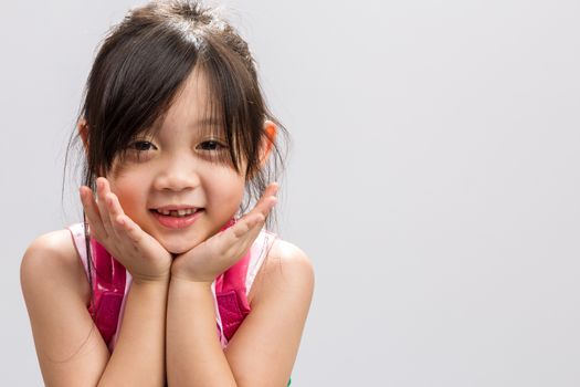 Cute Asian girl smiling, studio isolated white background.