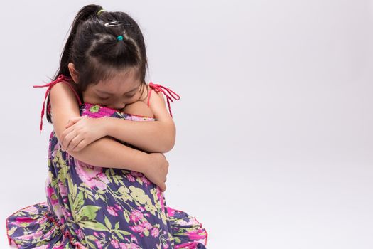 Worry little girl on isolated white background.