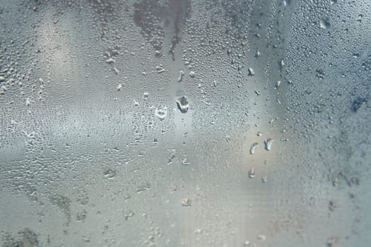 Bright grey color glassy texture, with water drops on it: abstract background