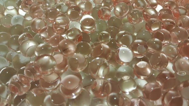 Closeup view with selective focus of shiny glittering orbeez or colorful water balls hydrogel. Water beads orbeez background.