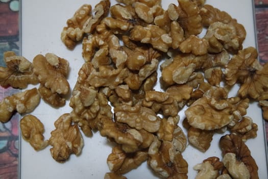 Close-up top view of peeled walnut on a white background. peeled walnut without shell ready to eat dry fruit.