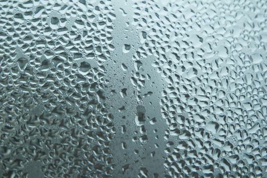 Bright grey color glassy texture, with water drops on it. Water drop glassy background