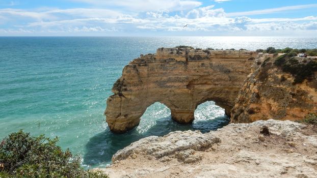 Panoramic view of the Algarve ocean cliffs, Portugal, with cloudy dramatic sky