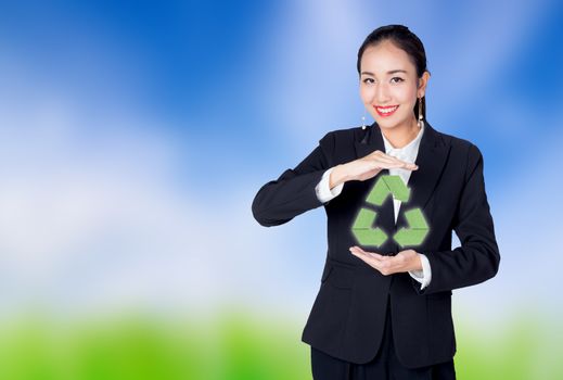 woman holding the recycle icon, symbol for recycling on nature background
