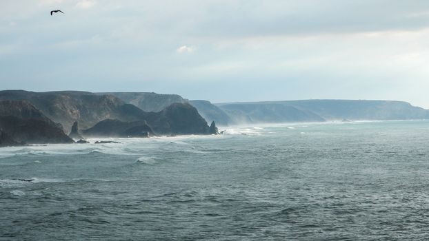 Panoramic view of the Algarve ocean cliffs, Portugal, the long coastline in the morning with a dramatic dreamlike atmosphere