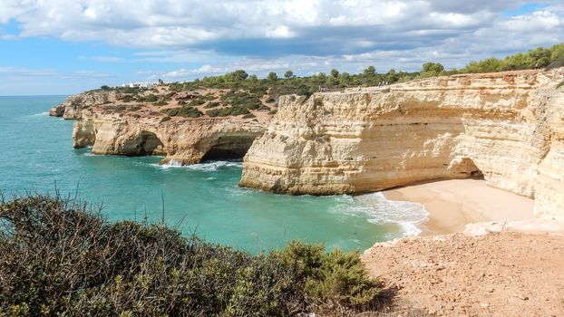 Panoramic view of the Algarve ocean cliffs, Portugal, with cloudy dramatic sky