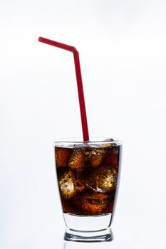 Cold drinking, soda with ice and red 

straw, glass of cola for hot and summer drink isolated on white background