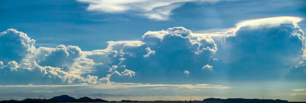 Panorama heap blue cloud and light blue sky and silhouette island