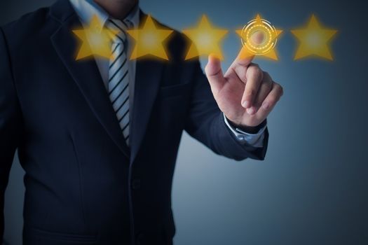 excellent service and best customer experience or good client , business man pointing at 5 stars rating on dark blue background 