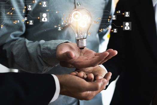 Innovation and idea of professional leader with teamwork holding lighting bulb with business icon and technology line, brainstorming teamwork and thinking management concept