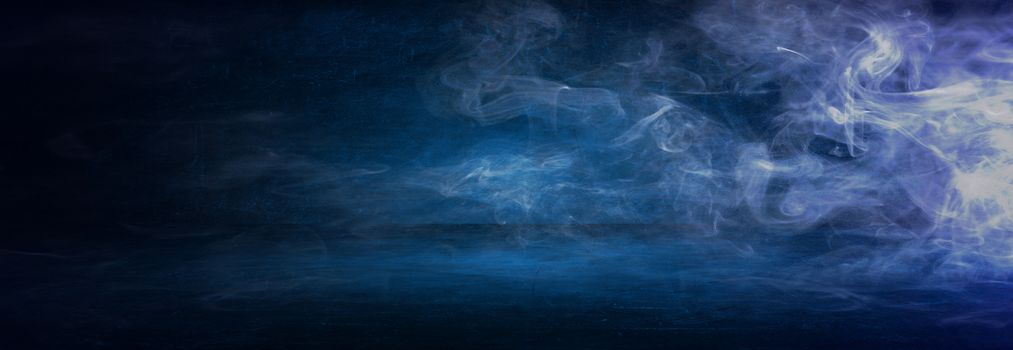 dark blue cement wall studio background with mist or fog, colorful smoke backdrop 