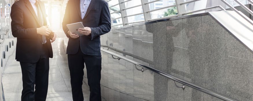 consult and team planing, financial collaboration concept, group of business people in suit looking on finance report in tablet as walking to office, brainstorming and talking about big project  