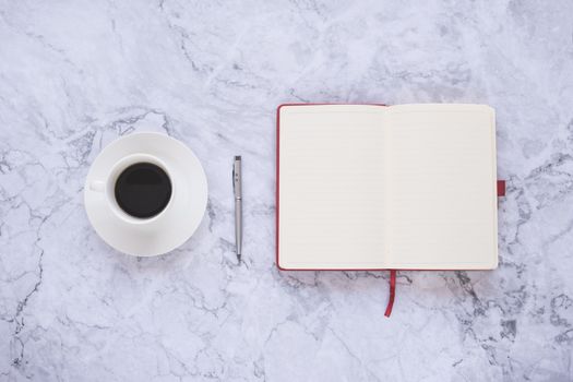 Flat lay creative and designer background with cup of coffee and office tools on white marble background 