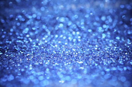 defocus of glitter vintage lights background. blue,white and black for Christmas and new year background.