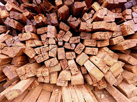 Terrible smell pile of extracted old wooden ties. Old oiled used oak railway sleepers stored after big reconstruction of old railway station. 