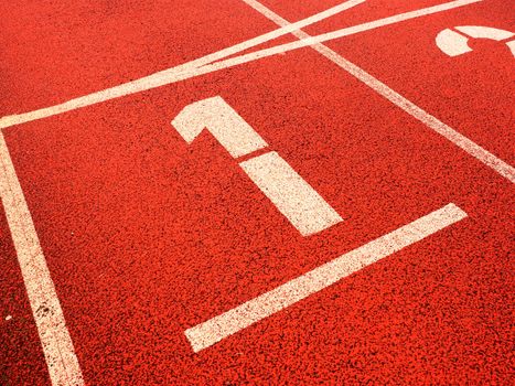 Number one. White track number on red rubber racetrack, texture of running racetracks in small stadium