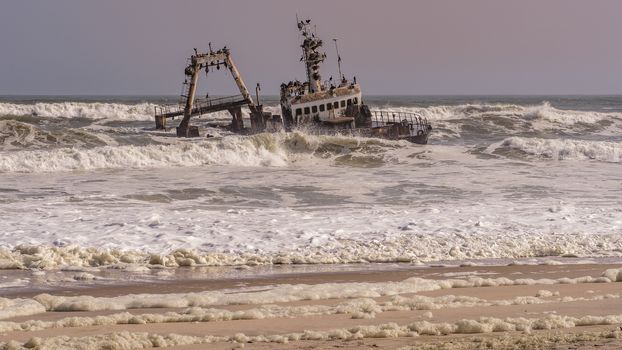 A shipwreck stranded on the beach in the Atlantic Ocean in the Skeleton Coast National Park in Namibia, Africa.
