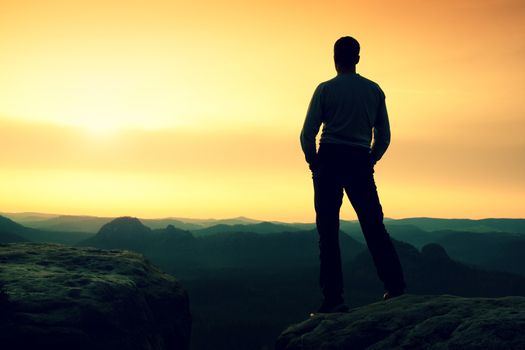 Silhouette of Young Confident and Powerful Man Standing with Hands on Hips, Late Day Sun with Copy Space