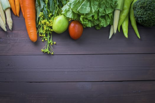 Healthy food, vegetables organic on wooden background, strong body concept and copy space below.